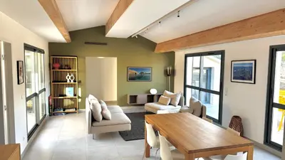 a living room with a wooden table and chairs at Sur le port, 150m2 - Parking gratuit, Climatisation, Terrasses - Standing in Bonifacio