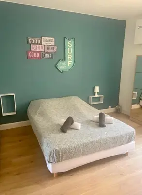 a bedroom with a bed with a sign on the wall at mare noi in Pietrosella