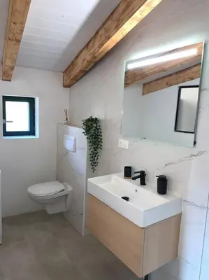 a bathroom with a white sink and a toilet at Caseddu au coeur du village in Monacia-dʼAullène
