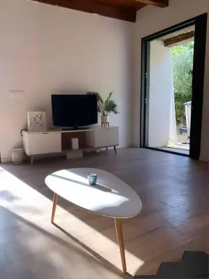 a living room with a tv and a coffee table at Caseddu au coeur du village in Monacia-dʼAullène