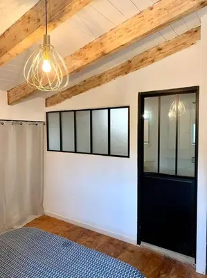 a room with a black door and a white wall at Caseddu au coeur du village in Monacia-dʼAullène