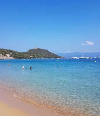 a group of people in the water at the beach at La vallée 2 in Belvédère