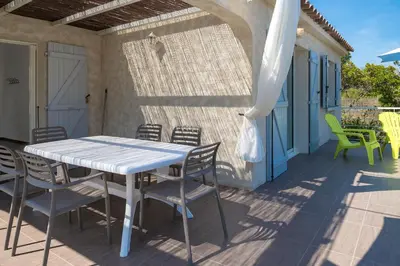 a white table and chairs on a patio at Domaine de Pianiccia in Favone