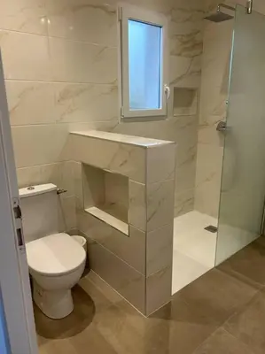 a white bathroom with a toilet and a shower at Villa mina in Ghisonaccia