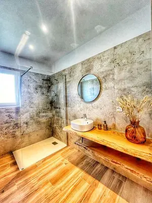 a bathroom with a sink and a mirror at A PIAZZOLA in Petreto-Bicchisano