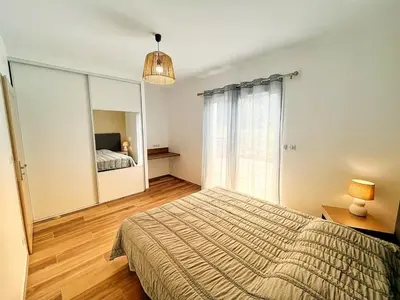 a bedroom with a bed and a large mirror at A PIAZZOLA in Petreto-Bicchisano