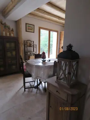a living room with a table and a window at l'altore di savaghju in Vivario