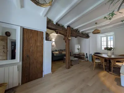 a living room with a table and a dining room at A Torra in Ville-di-Paraso