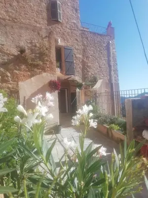 a building with flowers in front of it at A Torra in Ville-di-Paraso
