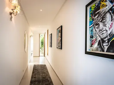 a hallway with art on the walls at Villa AzaiTu Suites in Porto-Vecchio