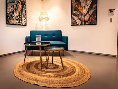 a living room with a blue couch and a table at Villa AzaiTu Suites in Porto-Vecchio