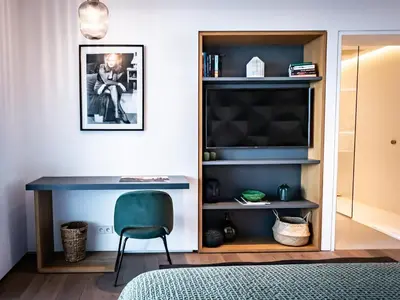 a bedroom with a blue desk and a chair at Villa AzaiTu Suites in Porto-Vecchio