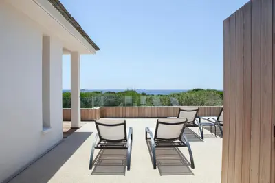 a row of chairs sitting on a patio at Villa AzaiTu Suites in Porto-Vecchio