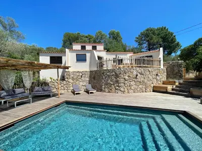a villa with a swimming pool and a house at Les Hauts de Capo - Domaine privé à proximité de Porto-Vecchio in Lecci