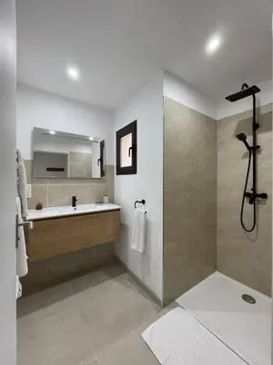 a bathroom with a tub and a sink and a mirror at Les Hauts de Capo - Domaine privé à proximité de Porto-Vecchio in Lecci