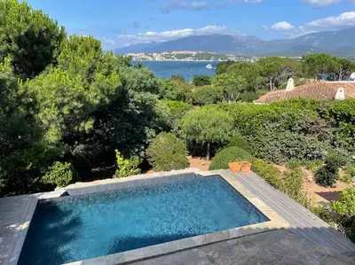 a swimming pool with a view of the water at Villa Bianca - Vue imprenable Mer & Porto-Vecchio, Piscine chauffée à débordement, Accès privé plage in Porto-Vecchio