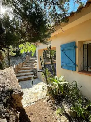 a house with a blue window and some stairs at Villa Bianca - Vue imprenable Mer & Porto-Vecchio, Piscine chauffée à débordement, Accès privé plage in Porto-Vecchio