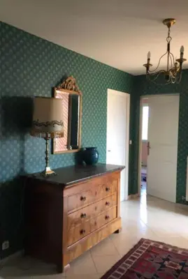 a room with a dresser and a mirror on a wall at Mare è Monte , jardin méditerranéen et exotique. in Ghisonaccia
