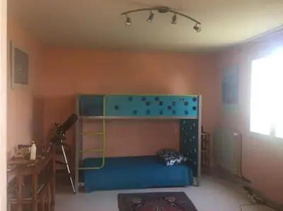 a bedroom with a bunk bed and a desk at Mare è Monte , jardin méditerranéen et exotique. in Ghisonaccia