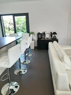 a living room with a white couch and white chairs at Villa élégante à Porto-Vecchio avec piscine privée in Porto-Vecchio