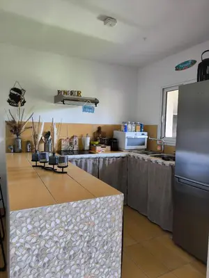 a kitchen with a counter top and a refrigerator at Havre de paix T3 vue mer in Conca