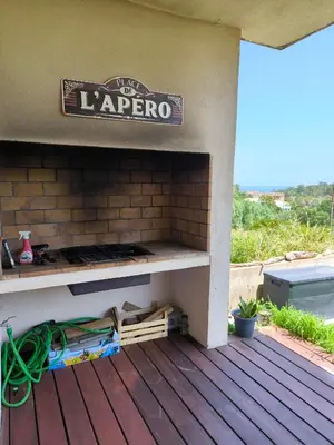 a outdoor oven with a sign on top on a deck at Havre de paix T3 vue mer in Conca