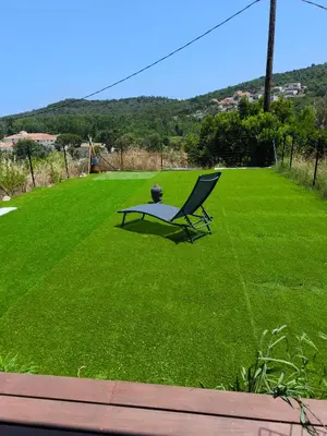 a chair sitting in a field of grass at Havre de paix T3 vue mer in Conca