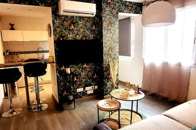 a living room with a couch and a table at Magnifique T2 in Ajaccio
