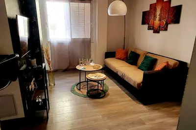 a living room with a couch and a table at Magnifique T2 in Ajaccio