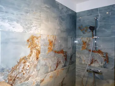 a bathroom with a painting of the ocean on the wall at Apartment Villa Kalliste by Interhome in Favone