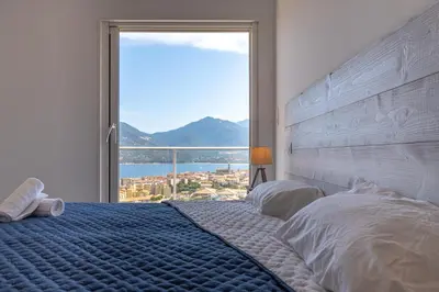 a bedroom with a bed with a large window at Casa a cucina in Propriano