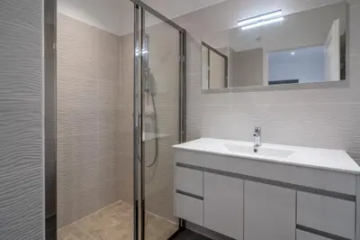 a white bathroom with a sink and a shower at Casa a cucina in Propriano
