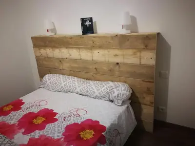a bedroom with a bed with red flowers on it at Maison en Corse in Monacia-dʼAullène
