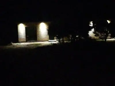 a house lit up at night with lights at Maison en Corse in Monacia-dʼAullène