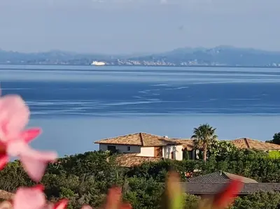 a house on a hill next to the water at villa CASA TOTTI vue mer avec piscine in Porto-Vecchio
