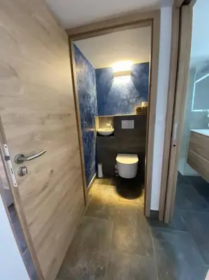 a bathroom with a toilet and a sink and a door at villa CASA TOTTI vue mer avec piscine in Porto-Vecchio