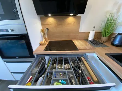 a kitchen with a drawer full of cooking utensils at villa CASA TOTTI vue mer avec piscine in Porto-Vecchio