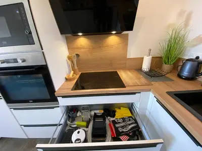 a small kitchen with a stove and a sink at villa CASA TOTTI vue mer avec piscine in Porto-Vecchio