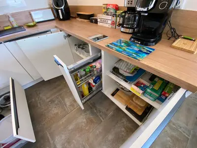 a kitchen with a counter with an open refrigerator at villa CASA TOTTI vue mer avec piscine in Porto-Vecchio