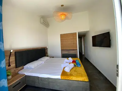 a bedroom with a bed with two stuffed animals on it at villa CASA TOTTI vue mer avec piscine in Porto-Vecchio