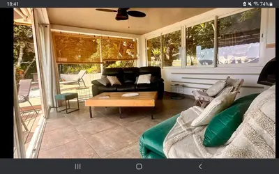 a living room with a couch and a table at Villa ANCHORAGE vue mer panoramique Roof top Piscine a debordement in Porto-Vecchio