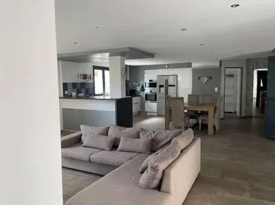 a living room with a couch and a dining room at Villa 3 chambres avec piscine privative in Ajaccio