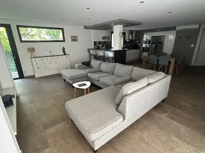 a living room with a couch and a kitchen at Villa 3 chambres avec piscine privative in Ajaccio