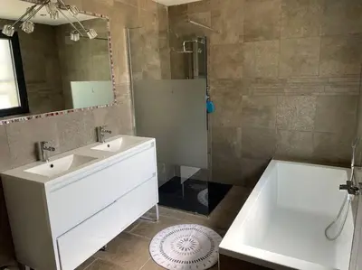 a bathroom with a white sink and a shower at Villa 3 chambres avec piscine privative in Ajaccio