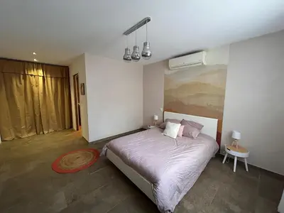 a bedroom with a bed with purple sheets and pillows at Villa 3 chambres avec piscine privative in Ajaccio