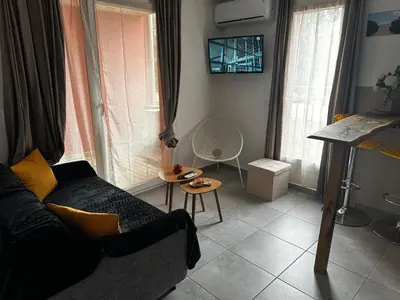 a living room with a couch and a table at Résidence les Hameaux de Saint Cyprien appartement LUNA 132 in Lecci