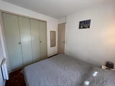 a bedroom with a bed and white cabinets at Bella Vista 34 , T2 vue mer, piscine ,climatisé Porticcio in Porticcio