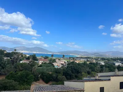 a view of a town with the ocean in the background at Bella Vista 34 , T2 vue mer, piscine ,climatisé Porticcio in Porticcio
