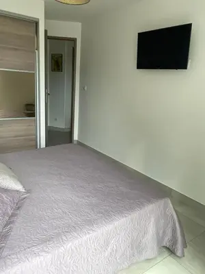 a bedroom with a bed and a flat screen tv at Appartement en bas de villa in Ocana