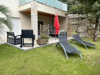 a group of chairs sitting on a patio at Appartement en bas de villa in Ocana
